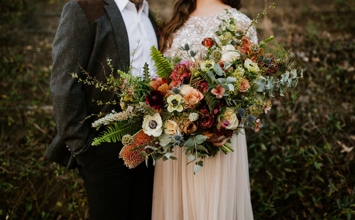Fall texture ferns, white panda anemone, golden banksia fall wedding bouquet, as captured in the studio of a Memphis, TN-based boutique floral design studio. The perfect choice for a romantic and timeless wedding