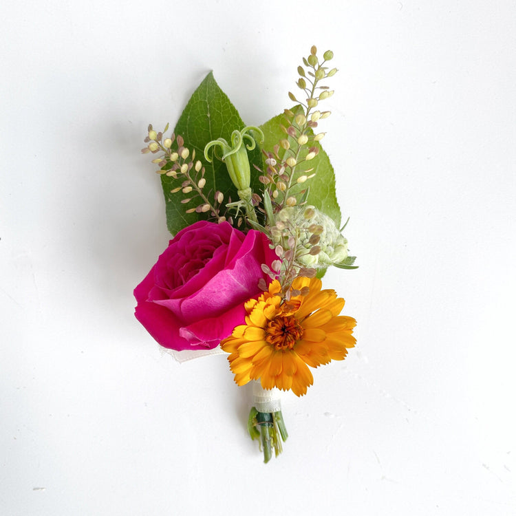Boutonniere with red rose and yellow sunflower. Floral arrangement completed by Everbloom Design a Memphis, Tennessee based floral studio.