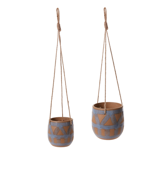 Two hanging ceramic planters with geometric patterns on a white background