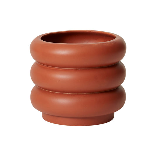 A whimsical yet modern silhouette of a terra-cotta pot with a stacked design.