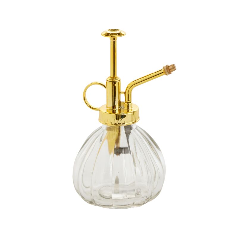 Clear glass bottle with gold metal nozzle on a white background