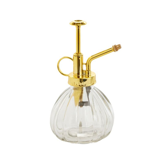 Clear glass bottle with gold metal nozzle on a white background
