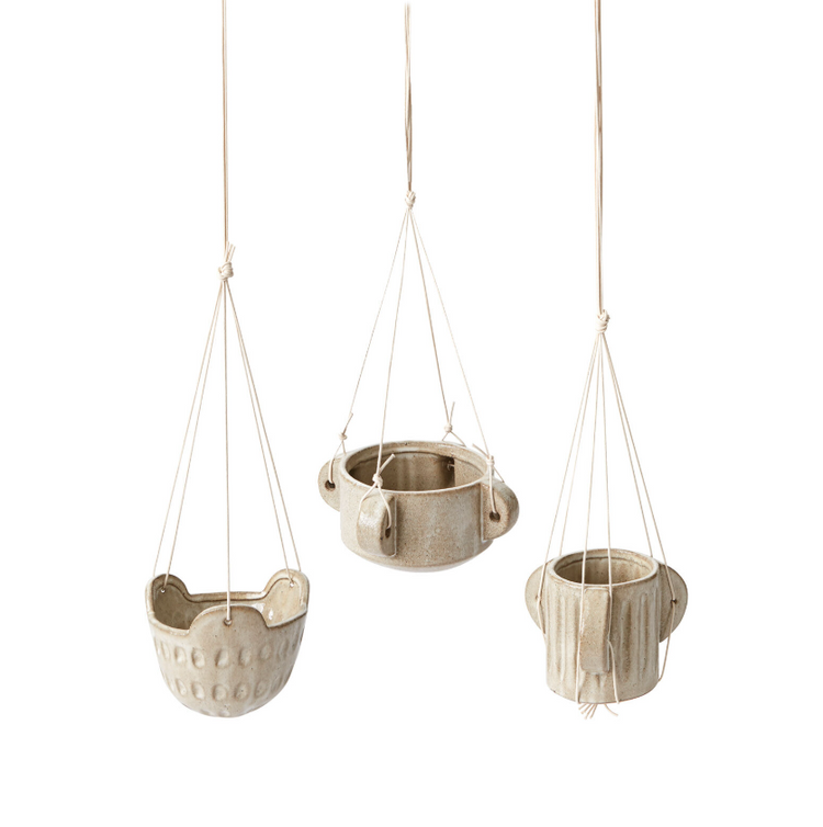 Three hanging ceramic planters on a white background