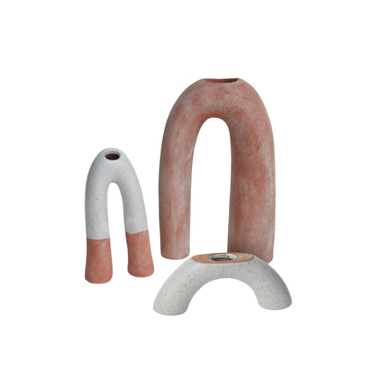 Three ceramic candle holders, one white with red accents and the other red, one completely white on a white background.