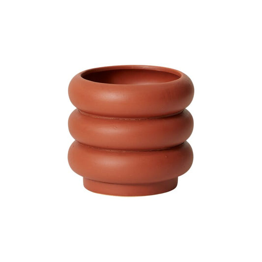 small Terracotta-colored planter with stacked cylindrical design on a white background