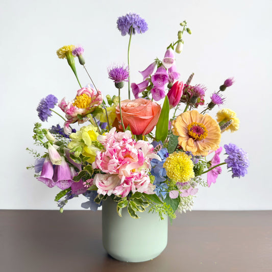 colorful bold summer arrangement in white vase