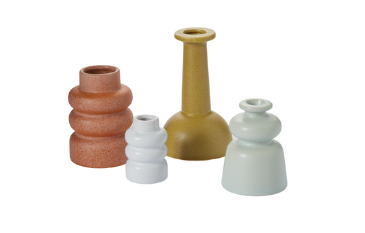 Set of four ceramic vases in different colors on a white background