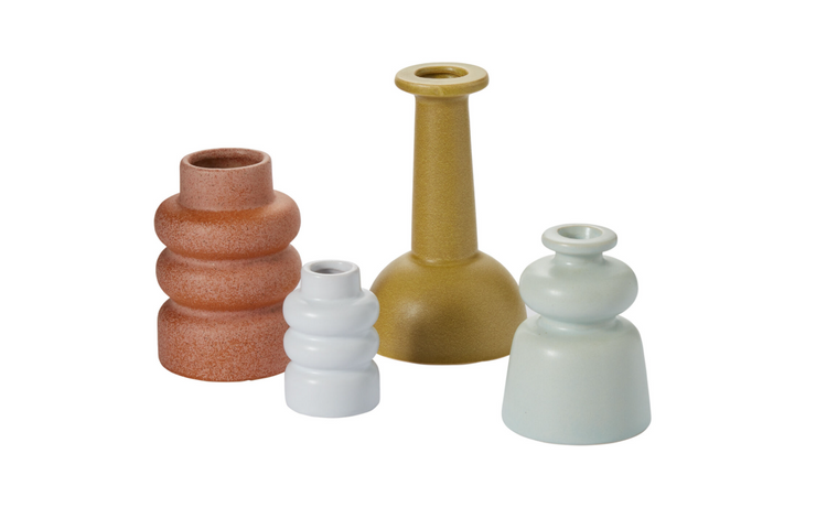 Set of four ceramic vases in different colors on a white background