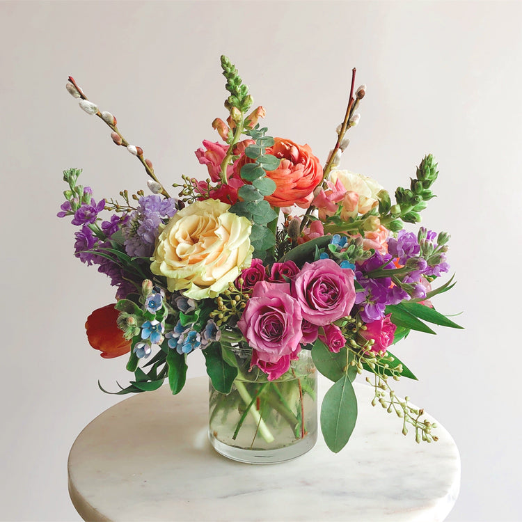 Seasonal arrangement pictured in cylindrical glass vase.  Floral arrangement completed by Everbloom Design a Memphis, Tennessee based floral studio.