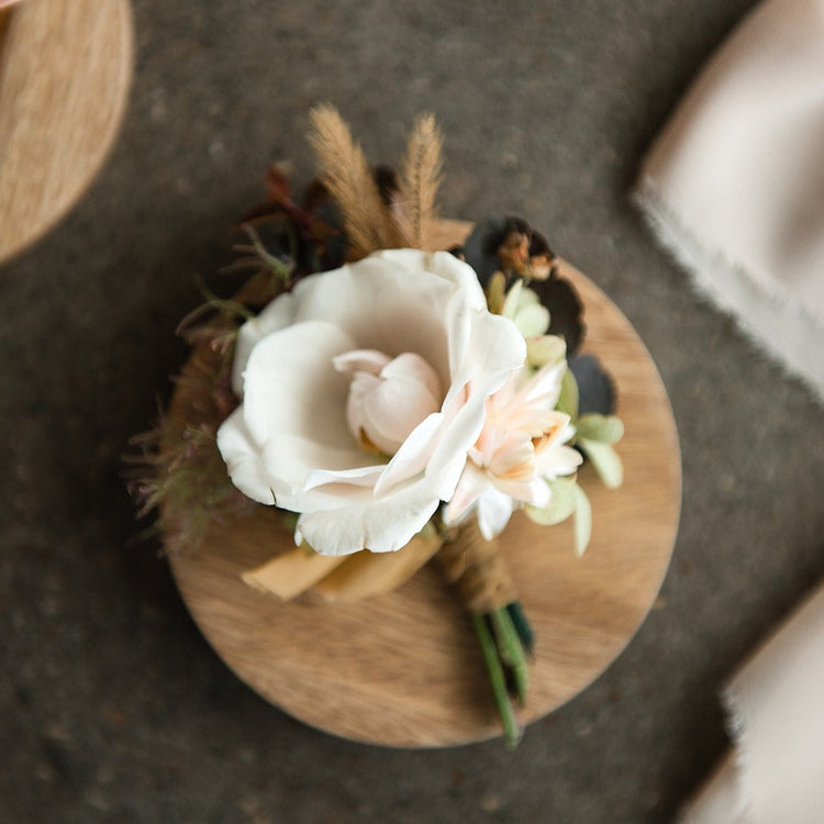 Boutonniere with white colored flowers. Floral arrangement completed by Everbloom Design a Memphis, Tennessee based floral studio.