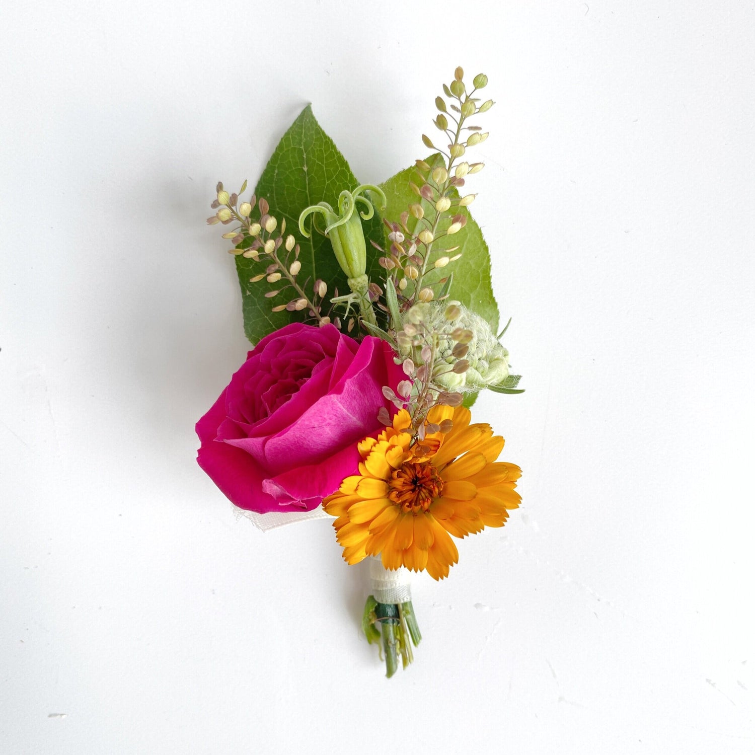 Boutonniere with red rose and yellow sunflower.  Floral arrangement completed by Everbloom Design a Memphis, Tennessee based floral studio.